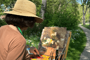 A woman painting outdoors.