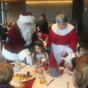 Santa and Mrs. Claus engage with children at Breakfast with Santa at Ford House.